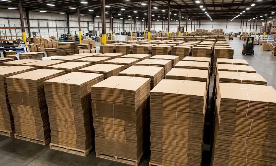 Panoramic view of flat-stacked corrugated boxes in warehouse